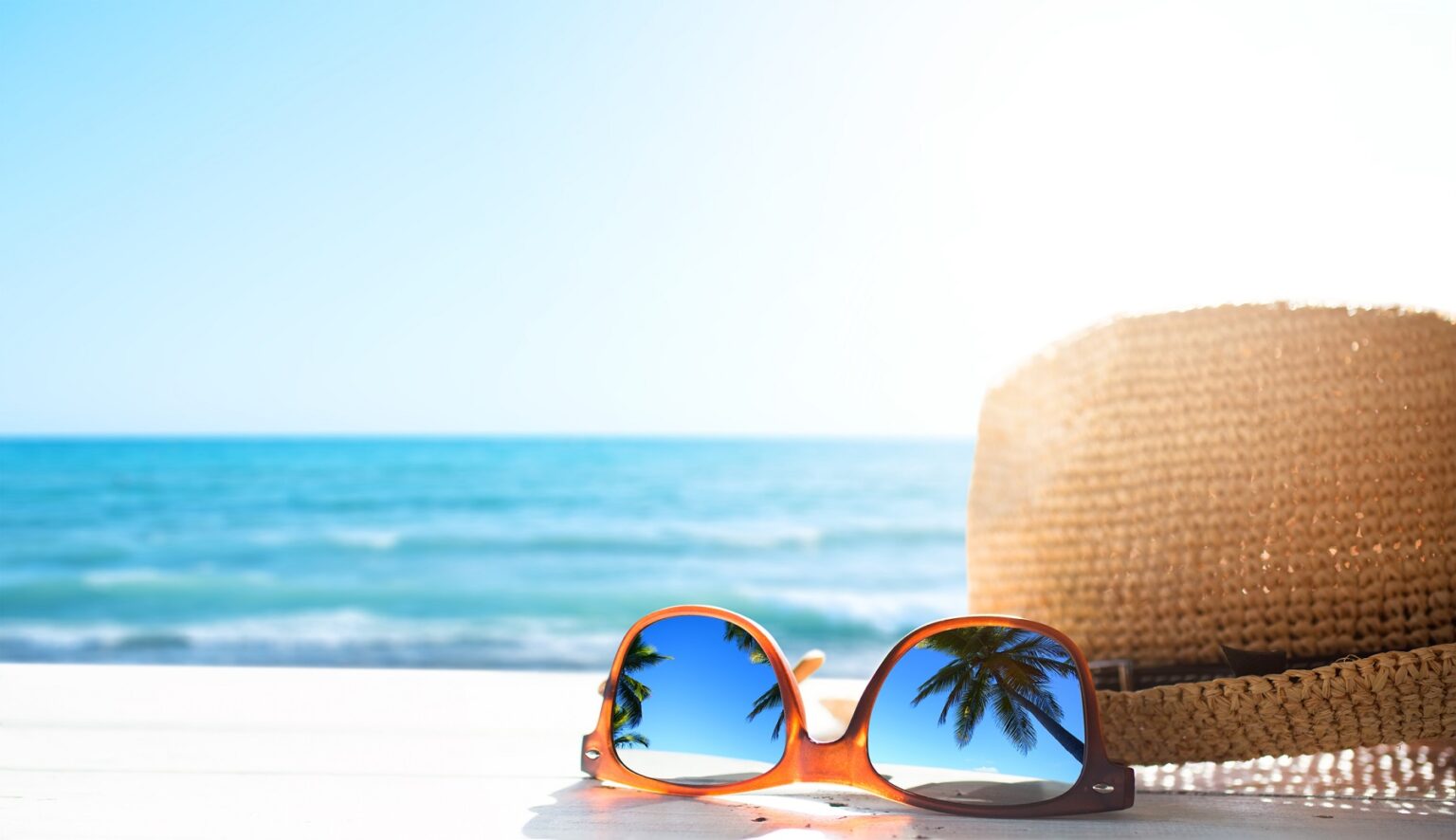 hat and sunglasses on a Vacation Rentals Vs. Hotels
