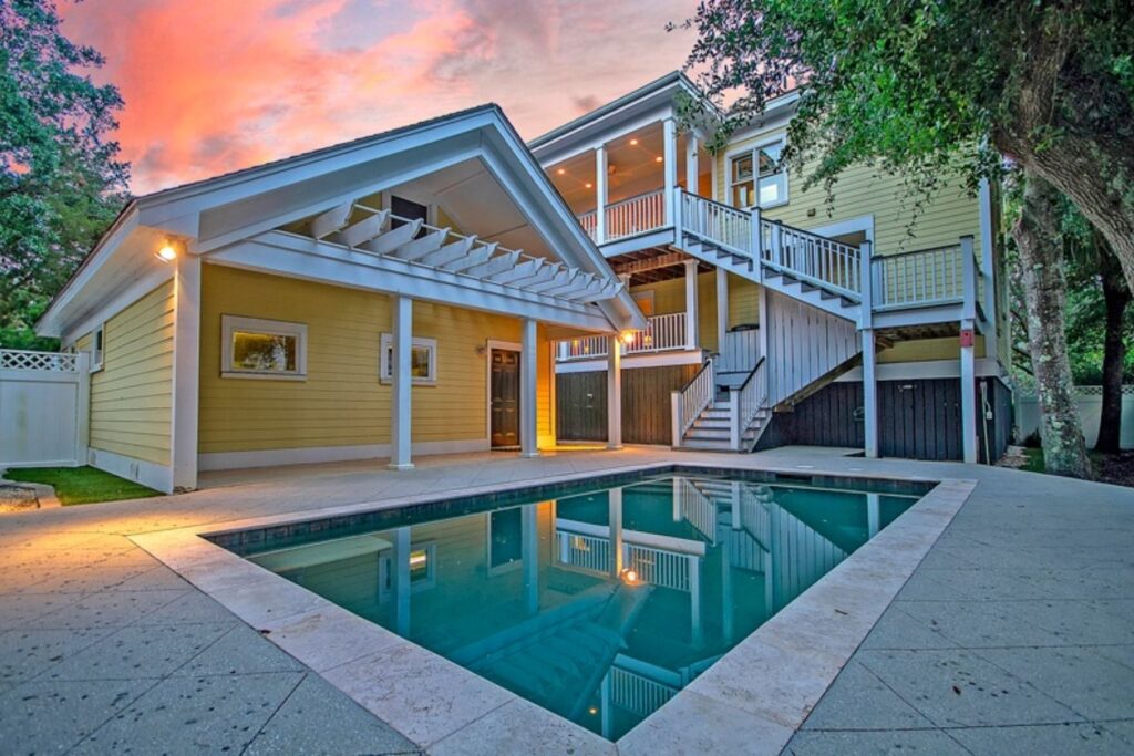 A house with a pool during sunset