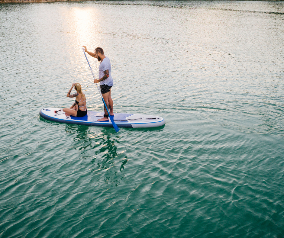 Couple paddleboarding. 